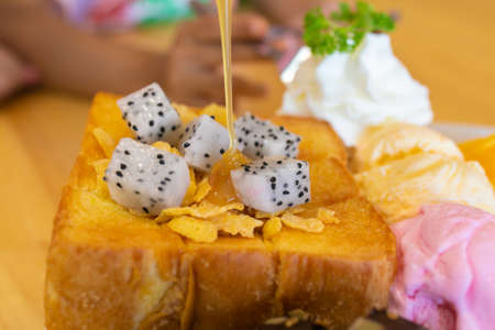 Honey toast, with vanilla and strawberries  ice cream serve with fresh fruits, delicious menu in the...