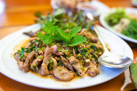 Spicy slide grilled pork salad (with green vegetables and chillies, Thai food.)の写真素材