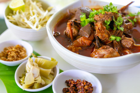 Thai rice noodles with (northern) Lanna curry called nam ngio. Thai food.の写真素材