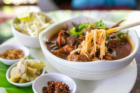 Thai rice noodles with (northern) Lanna curry called nam ngio. Thai food.の写真素材