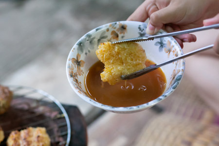Khao jee a street food Thai style grill sticky rice, with egg paste.の写真素材