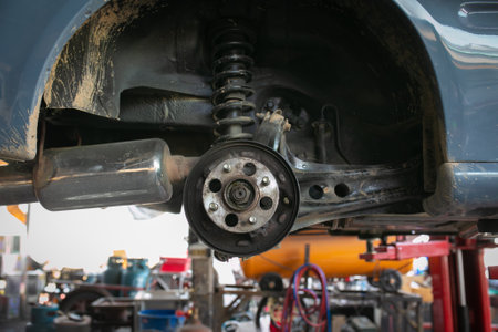 Car suspension and wheel of the lifted car in the repair shop.