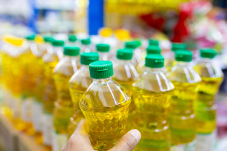 Plastic bottles of vegetable oil in the supermarket. Selective focus.の写真素材