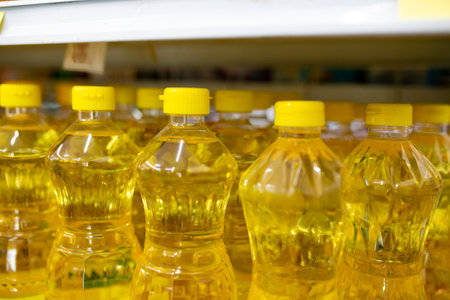 Plastic bottles of sunflower oil on shelf in supermarket, closeupの写真素材