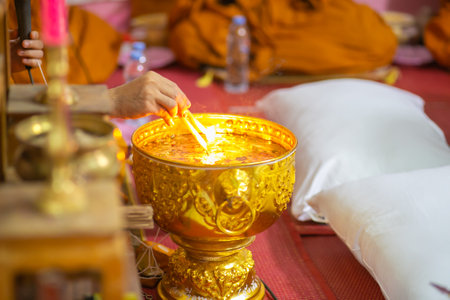 Burning candle in buddhist monk's hand, Thailand.