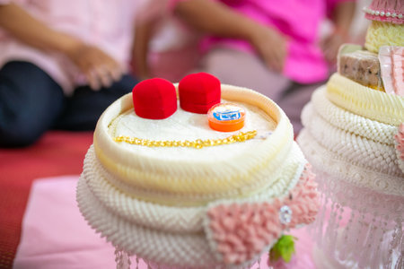 Buddhist wedding cake with red and white beads on top.の写真素材
