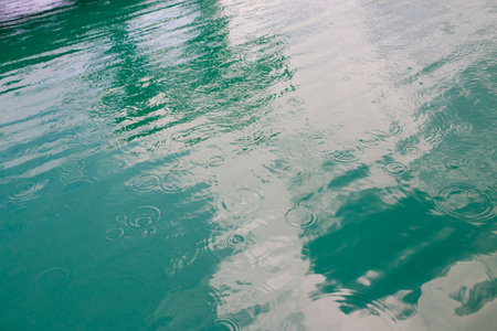 Reflection in the water of a lake with ripples and wavesの写真素材
