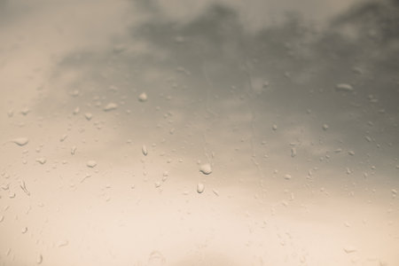 Rain drops on the glass. Abstract background for design. Toned.の写真素材