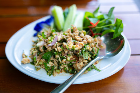 Spicy minced pork salad on wood table, Thai style food.の写真素材