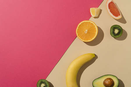 Fresh summer fruit arrangement. Pink and beige background with copy space.の写真素材