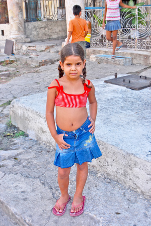 HAVANA, CUBA, MAY 11, 2009  A small girl in the age of five standing in a yard made of concrete in Havana, Cuba, on May 11th, 2009  のeditorial素材