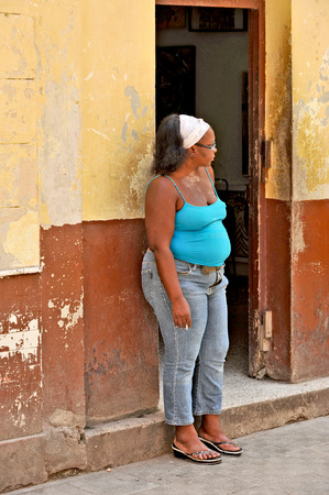 HAVANA, CUBA, MAY 6, 2009  A woman leaning on a wall on a street in Havana, Cuba, on May 7th, 2009 のeditorial素材