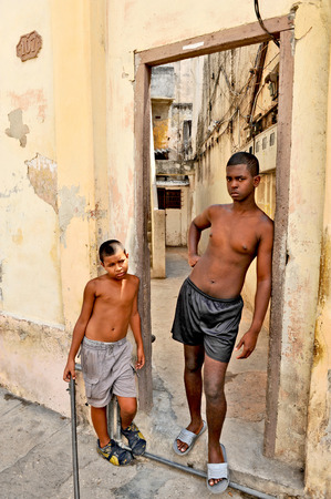 HAVANA, CUBA, OCTOBER 20, 2009  Two young boys posing in a doorway, in Havana, Cuba, on October 20th, 2009のeditorial素材