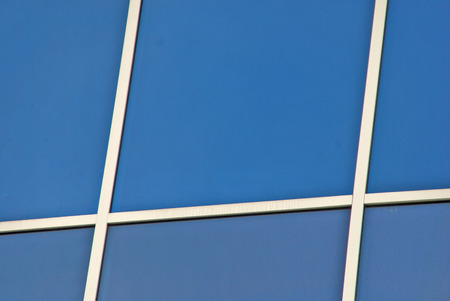 Merida, Yucatan,Mexico, 2008  Glass windows with white frames reflecting blue sky and white clouds 