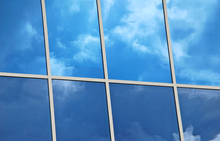 Merida, Yucatan,Mexico, 2008  Glass windows with white frames reflecting blue sky and white clouds 