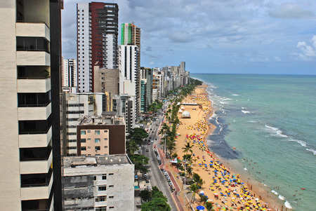 Recife, Pernambuco, Brazil, 2009  A view to the city beach with lots of Brazilian people sunbathing and swimming, and umbrellas, a view from the top of a skyscraper のeditorial素材
