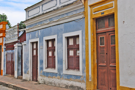 OLINDA, RECIFE, BRAZIL, SEPTEMBER 1, 2009  Beautiful colourful houses in Olinda, Recife, Brazil, on September 1st, 2009  The front cacade of a pictoresque old house with blue and white walls, brown window doors and and a brown door with ocra surroundings のeditorial素材