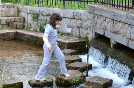 BITOLA, MACEDONIA, MAY 19, 2011  Children at the age of seven or eight playing around a water pond in an amusement park in Bitola, Macedonia, on May 19th, 2011 のeditorial素材