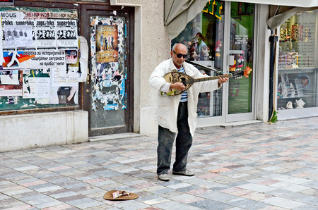 OHRID, MACEDONIA, MAY 17, 2011  A street musician playing and singing on the street, in Ohrid, Macedonia, on May 17th, 2011 のeditorial素材