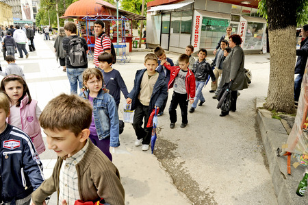 PRILEP, MACEDONIA, MAY 6, 2011  A group of children in the age of five  walking on a pedestrian street in a park in Prilep, Macedonia, on May 6th, 2011 のeditorial素材