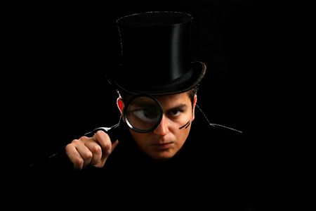 young agent in cylinder hat with magnifying hatの写真素材