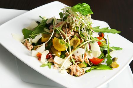 salad with tuna on the plate over tableの写真素材