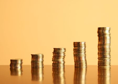 towers of gold coins on the tableの写真素材