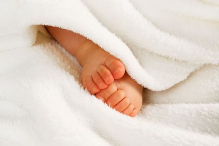 two small baby girl legs on the white backgroundの写真素材