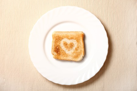 Toast with hearth shape on it on the white plate