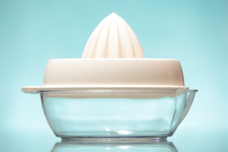 A white and transparent squeezer over blue background
