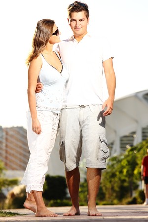 A young nice couple smiling and walking in the parkの写真素材