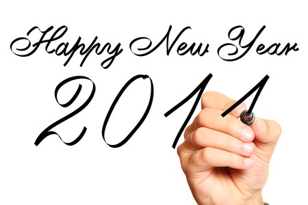 Male hand writing New Year's wishes over white backgroundの写真素材