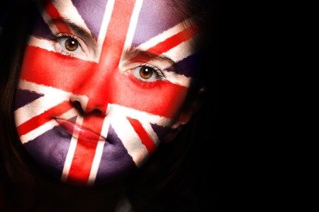 A close up of a british flag on a female face over dark backgroundの写真素材