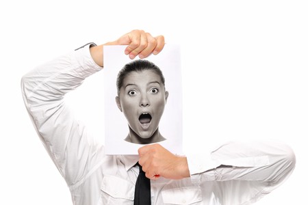 Businessman holding a piece of paper over his face with a shocked woman on itの写真素材