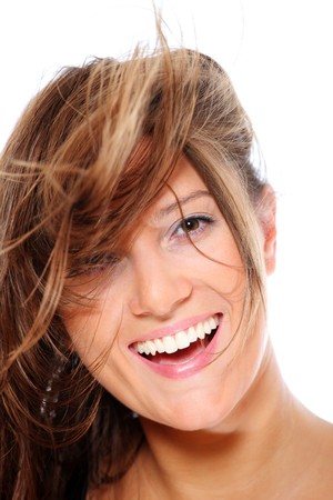 A portrait of a young happy woman smiling over white backgroundの写真素材