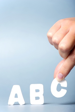 A picture of female hand putting letters abc in a rowの写真素材