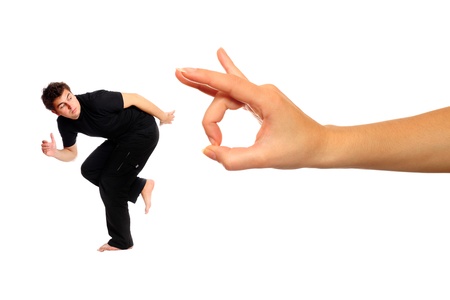 A picture of young man running away from big hand over white background