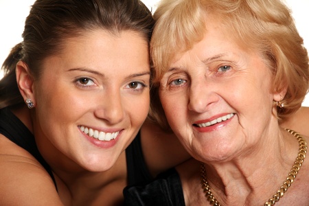 A portrait of a granddaughter hugging her grandma over white background