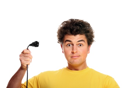 A picture of a goofy young man with a cable standing against white backgroundの写真素材