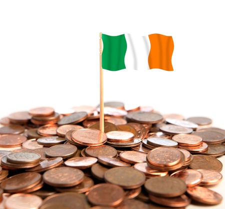 A picture of a group of coins and an Irish flag in the middle of it over white backgroundの写真素材