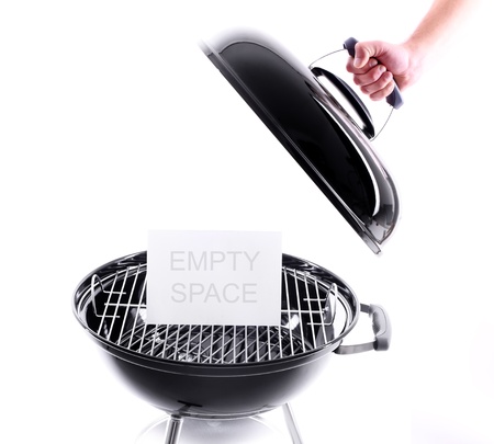 A picture of a new black grill and a hand holding the cover. Ready space for some textの写真素材