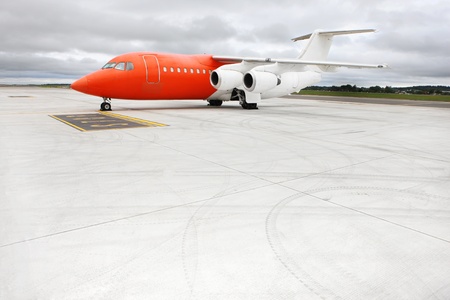 A picture of an orange business jet on the apron, space for your textの写真素材