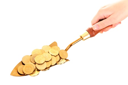 A picture of a small shovel full of golden coins over white backgroundの写真素材