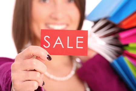 A picture of a young happy woman with shopping bags over white background