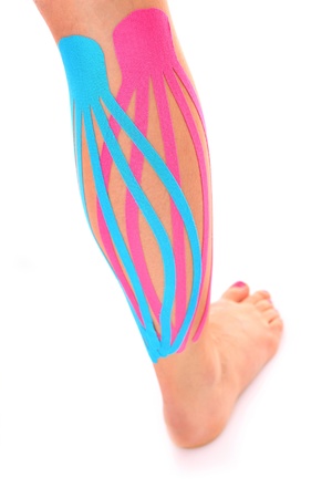 A picture of a special physio tape put on an injured calf over white background