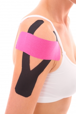 A picture of a special physio tape put on an injured arm muscles over white backgroundの写真素材