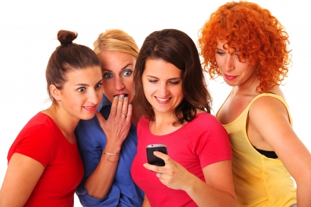A picture of a group of friends using a cellphone over white backgroundの写真素材