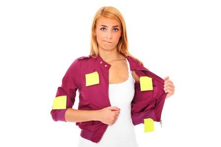 A portrait of a young confused woman with sticky notes all over her bodyの写真素材