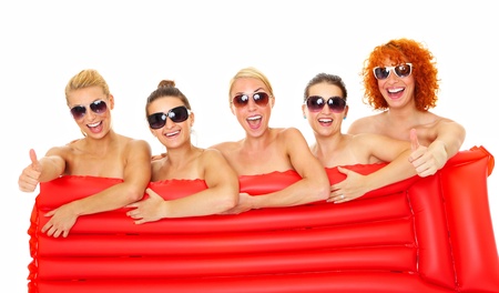 Picture of five happy women covering their body with a red mattress over white backgroundの写真素材