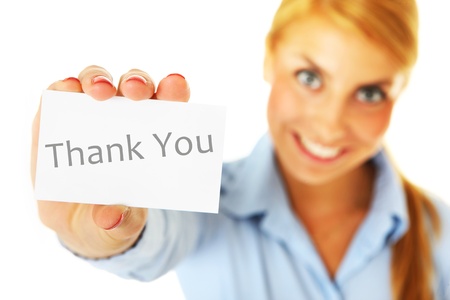 A blurry portrait of a woman showing a business card with a "thank you" inscription over white backgroundの写真素材